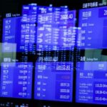 FILE PHOTO: Monitors displaying the stock index prices and Japanese