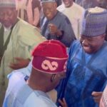 Bola Tinubu dances with a man, after he was declared