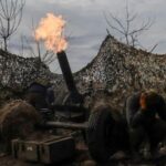 FILE PHOTO: Ukrainian service members fire a mortar towards Russian