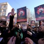 FILE PHOTO: Iranian protesters chant slogans as they hold pictures