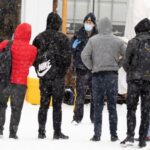 Asylum seekers cross into Canada from Roxham Road in Champlain