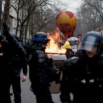French unions and workers march against pension reforms in Paris